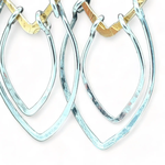 Sterling silver double teardrops swinging from stamped brass diamonds, all hanging from a braided brass link