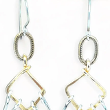 Sterling silver double teardrops swinging from stamped brass diamonds, all hanging from a braided brass link