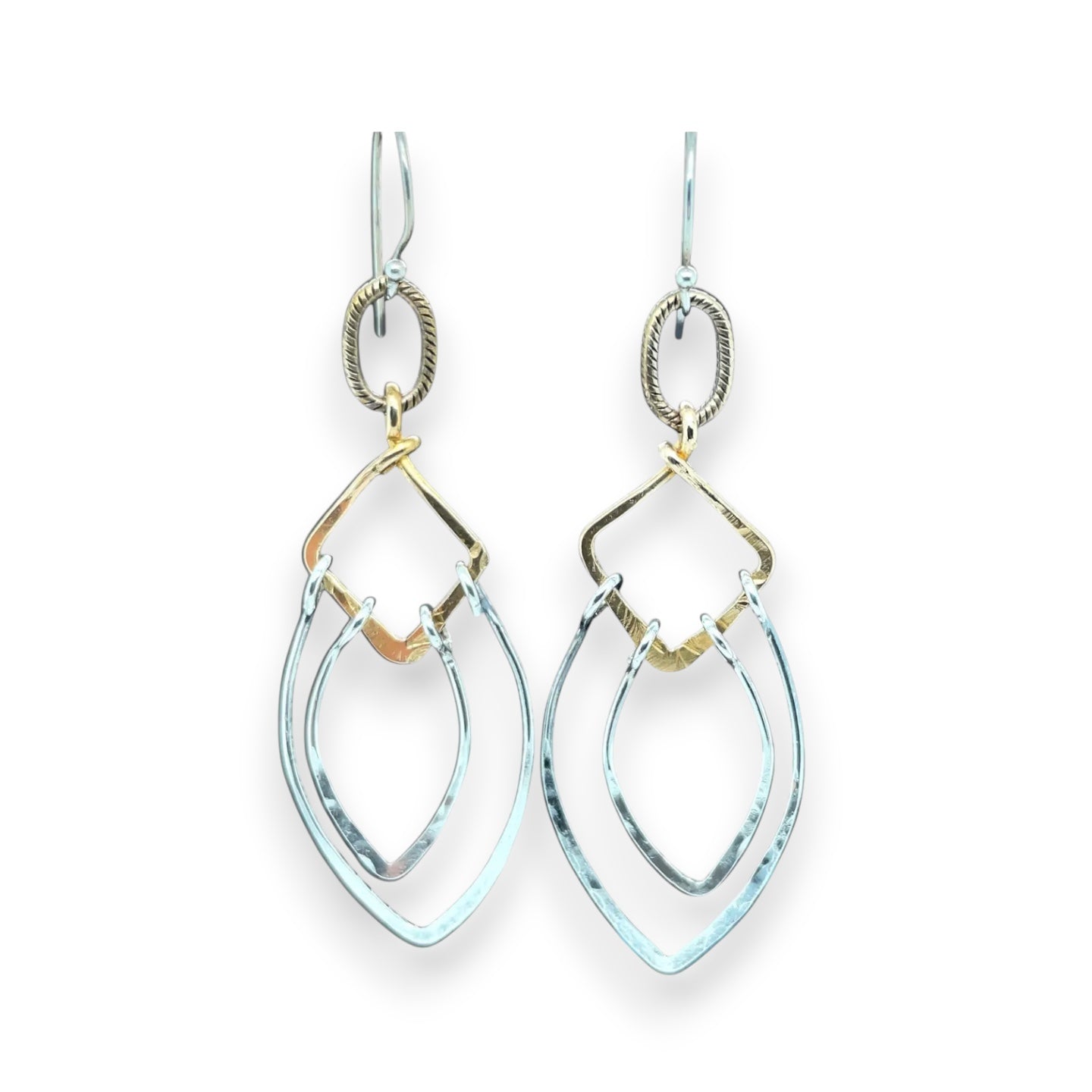 Sterling silver double teardrops swinging from stamped brass diamonds, all hanging from a braided brass link