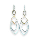 Sterling silver double teardrops swinging from stamped brass diamonds, all hanging from a braided brass link