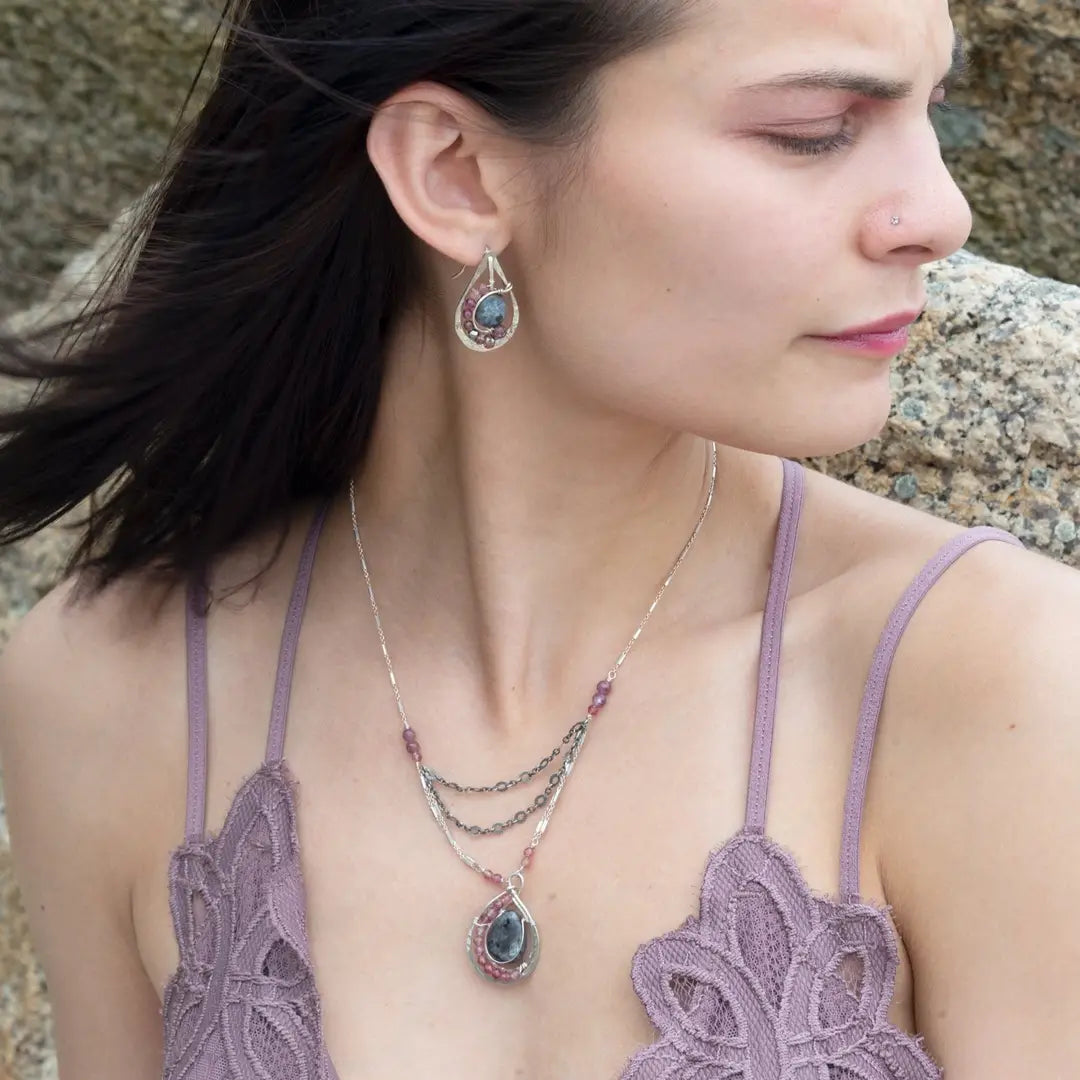 Floral stamped sterling silver drop earrings with larvikite smooth coins surrounded by pink tourmaline, lepidolite, and pyrite gemstones, with a built in earring hook that wears like a post earring