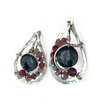 Floral stamped sterling silver drop earrings with larvikite smooth coins surrounded by pink tourmaline, lepidolite, and pyrite gemstones, with a built in earring hook that wears like a post earring