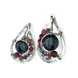 Floral stamped sterling silver drop earrings with larvikite smooth coins surrounded by pink tourmaline, lepidolite, and pyrite gemstones, with a built in earring hook that wears like a post earring