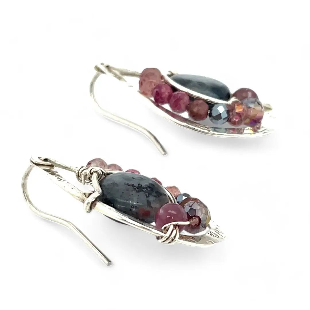 Floral stamped sterling silver drop earrings with larvikite smooth coins surrounded by pink tourmaline, lepidolite, and pyrite gemstones, with a built in earring hook that wears like a post earring