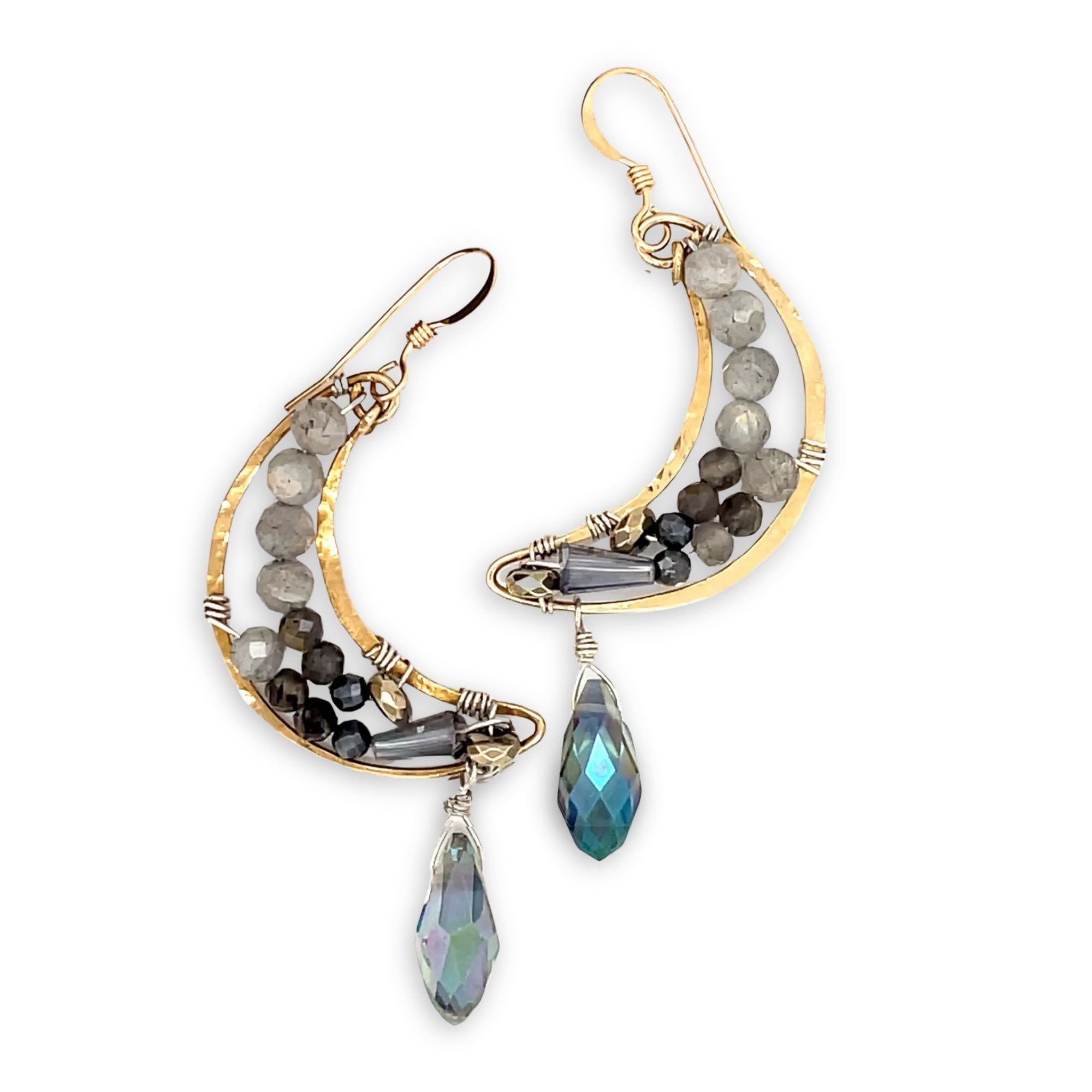 Handmade brass moon earrings with labradorite, iolite, pyrite, and crystal gemstones inside with a blue faceted crystal drop hanging from the bottom