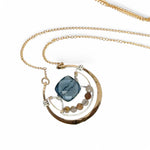 bronze circular pendant with sterling silver accents, london blue quartz square and rutilated quartz gemstones on gold filled chain necklace