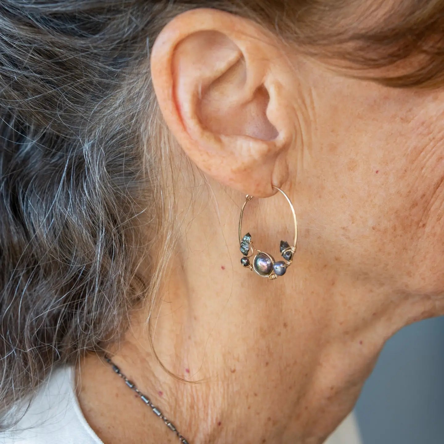 Olive and purple color fresh water pearl collection woven into a gold filled handmade hoop earring