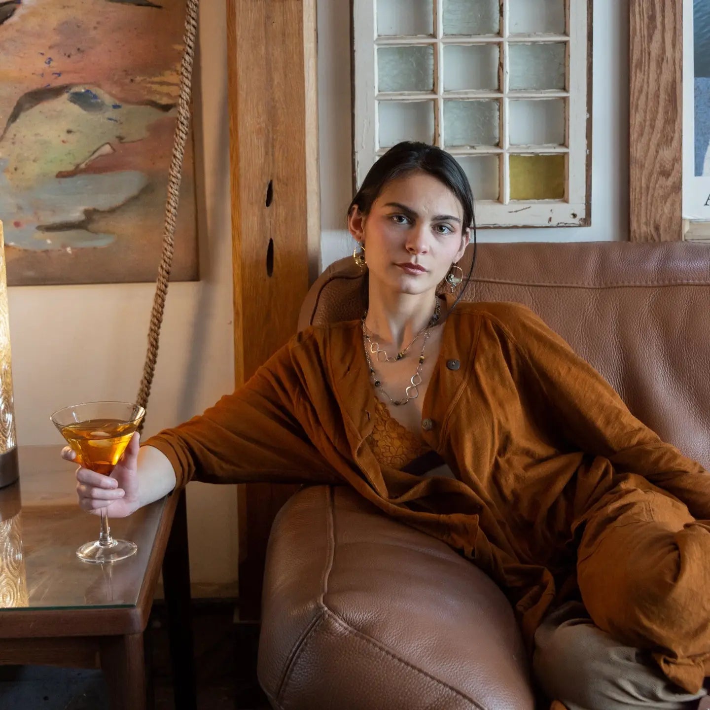 hammered bronze hoop earrings embroidered with a lemon quartz nugget, fresh water pearls, sparkly crystal, and cat's eye gemstones
