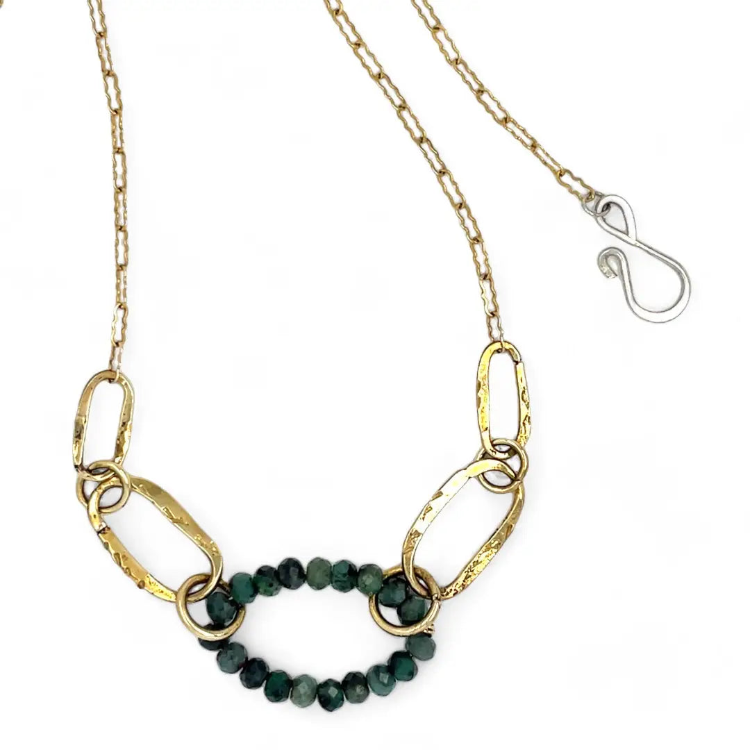 A gold-filled crinkle chain holding handmade brass links and an emerald ring  necklace