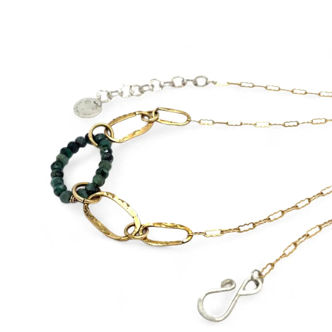 A gold-filled crinkle chain holding handmade brass links and an emerald ring  necklace
