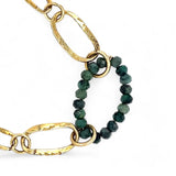 A gold-filled crinkle chain holding handmade brass links and an emerald ring  necklace