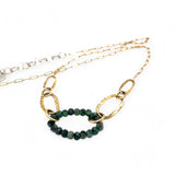 A gold-filled crinkle chain holding handmade brass links and an emerald ring  necklace