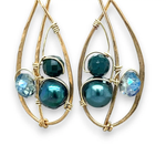 Green pearl, faceted bloodstone gemstone, and blue green crystal are nestled within brass infinity earrings on gold filled wire