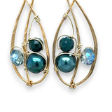 Green pearl, faceted bloodstone gemstone, and blue green crystal are nestled within brass infinity earrings on gold filled wire