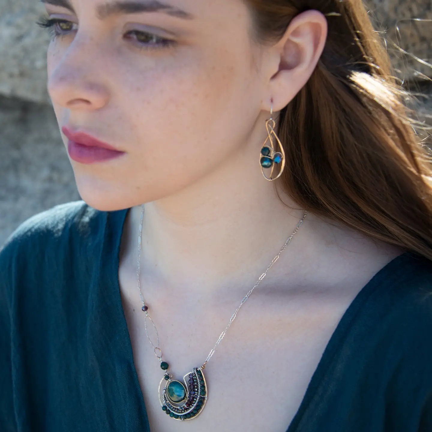 A  hand formed bronze pendant necklace with green fresh water pearl coin, bloodstone faceted gems, crystal, and pyrite on a sterling silver delicate chain with sparkly rose quartz links