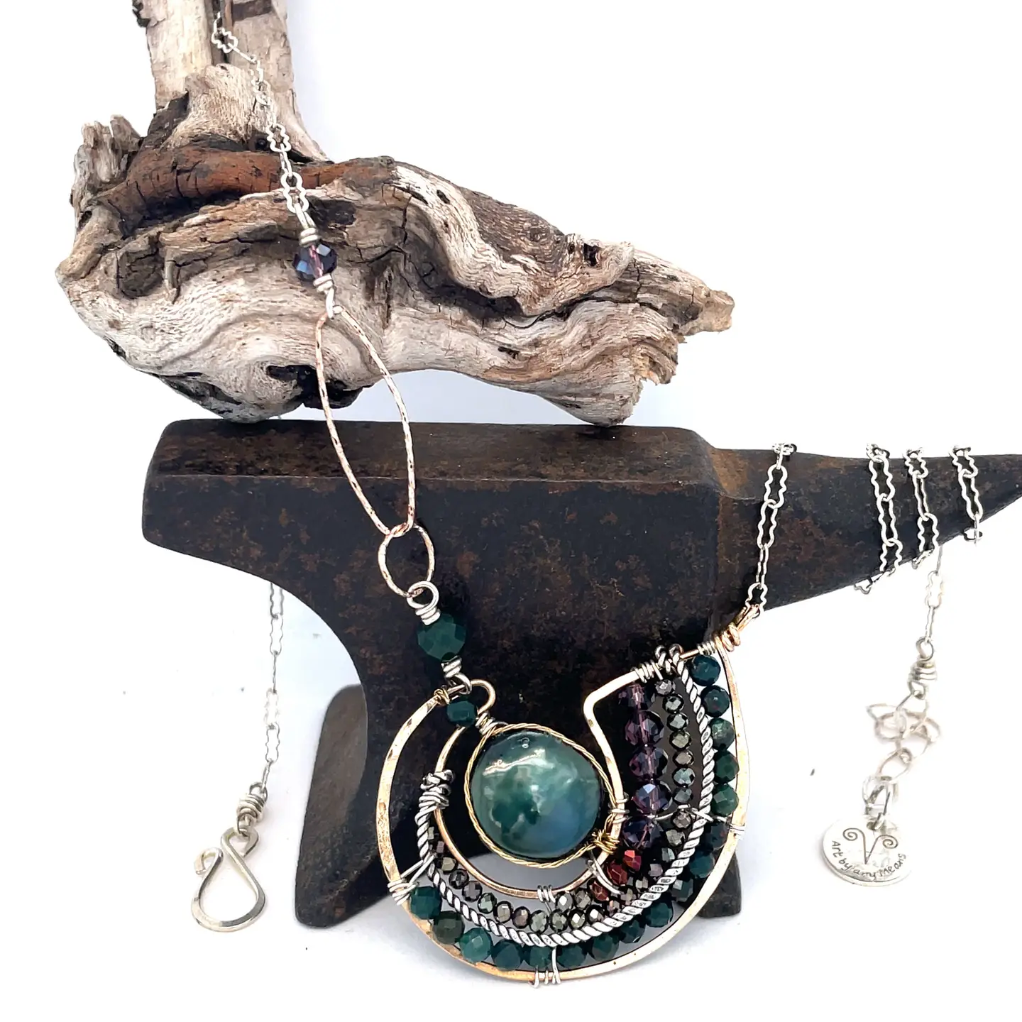 A  hand formed bronze pendant necklace with green fresh water pearl coin, bloodstone faceted gems, crystal, and pyrite on a sterling silver delicate chain with sparkly rose quartz links