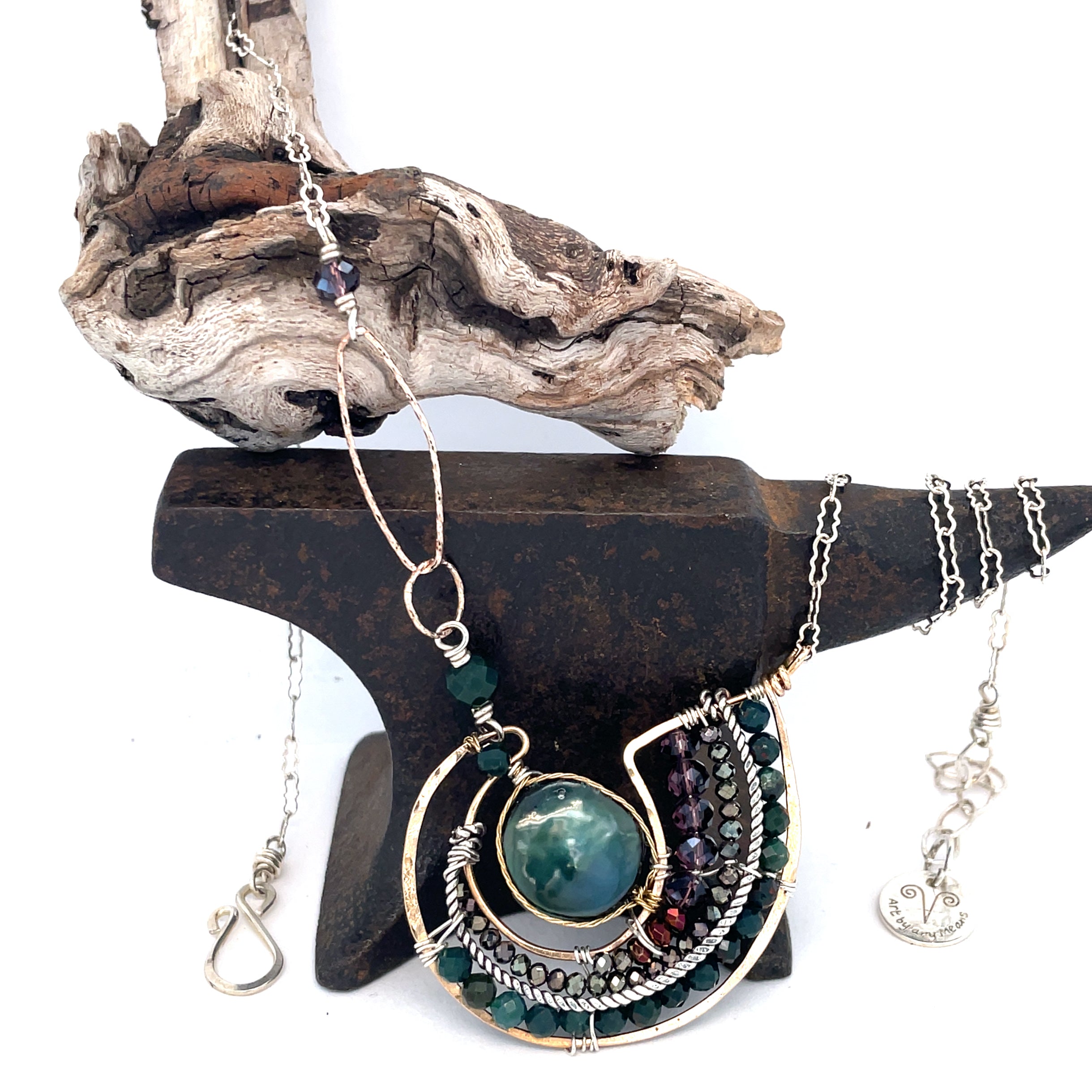 A  hand formed bronze pendant necklace with green fresh water pearl coin, bloodstone faceted gems, crystal, and pyrite on a sterling silver delicate chain with sparkly rose quartz links