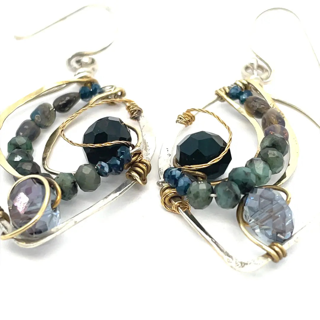 Crystal, emerald, and opal gemstones vein between layers of brass wire inside a sterling silver leaf shaped earring