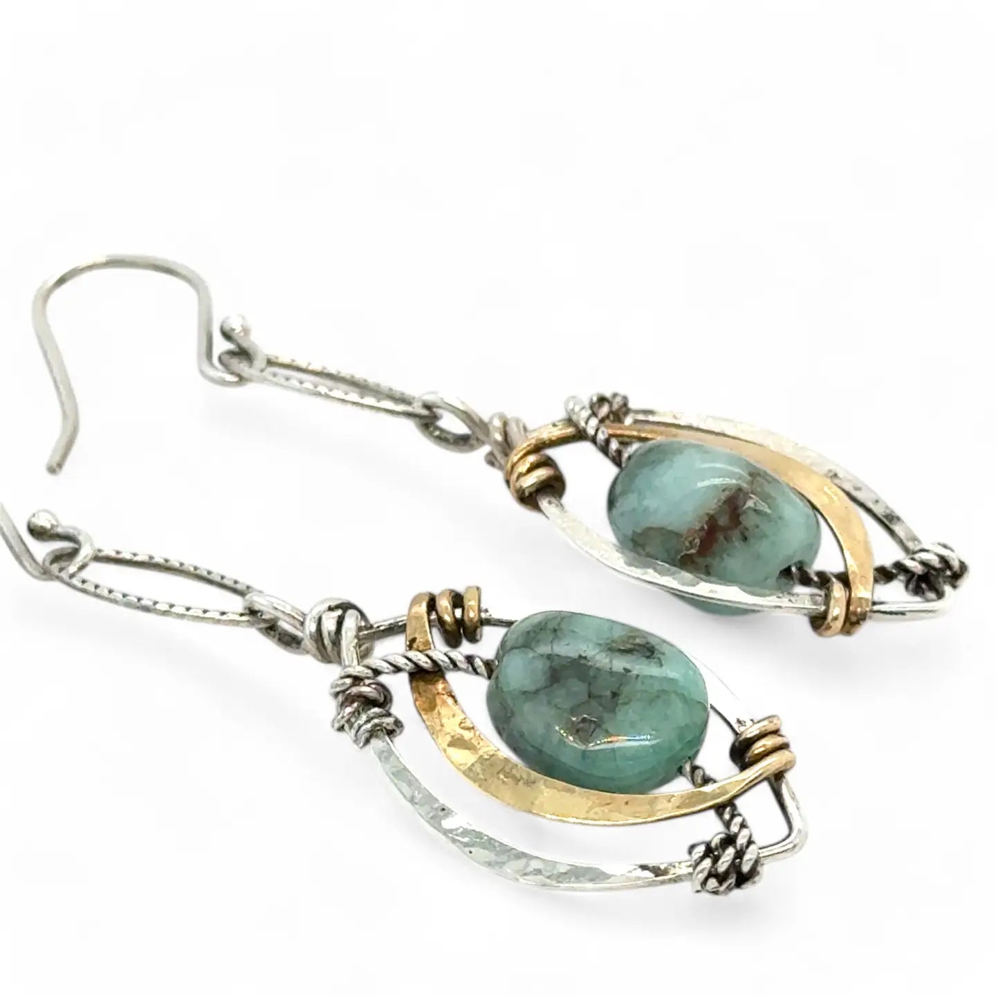 smooth green emerald nuggets on oxidized sterling silver twist wire inside a tiny hammered sterling silver marquise earrings with brass hammered accent