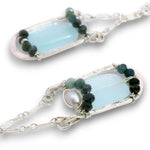 Leaf stamped sterling silver earrings on delicate chain featuring ombre blue tourmaline, fresh water pearl, and chalcedony gemstones