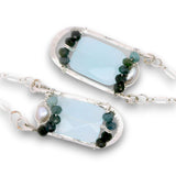 Leaf stamped sterling silver earrings on delicate chain featuring ombre blue tourmaline, fresh water pearl, and chalcedony gemstones