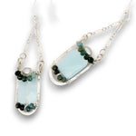 Leaf stamped sterling silver earrings on delicate chain featuring ombre blue tourmaline, fresh water pearl, and chalcedony gemstones