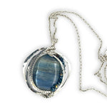 Large smooth oval kyanite gemstones encircled in hammered sterling silver and blue crystal gemstone necklace