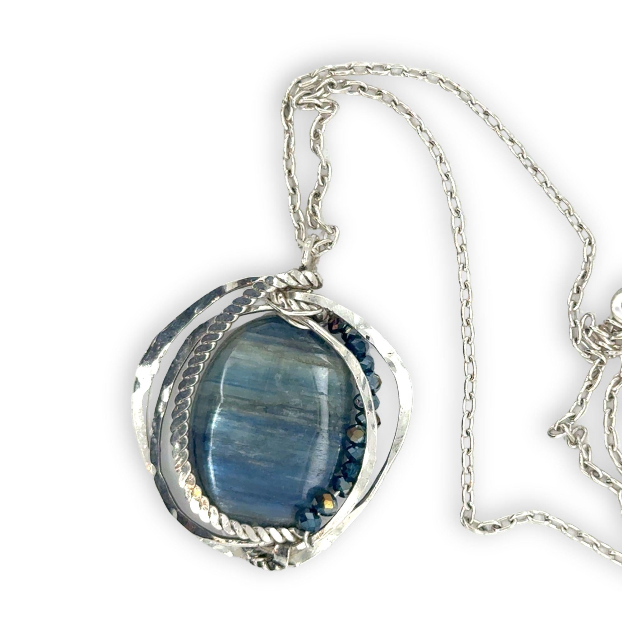 Large smooth oval kyanite gemstones encircled in hammered sterling silver and blue crystal gemstone necklace