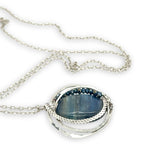 Large smooth oval kyanite gemstones encircled in hammered sterling silver and blue crystal gemstone necklace
