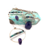 Handmade hammered bronze pendant with built in amethyst nugget, accented with opal and green amethyst on sterling silver wire, featuring a sterling silver chain