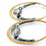 pyrite gemstones mixed with a silver sparkling coin crystal wrapped in gold filled wire inside a brass hammered hoop on gold filled earring hooks