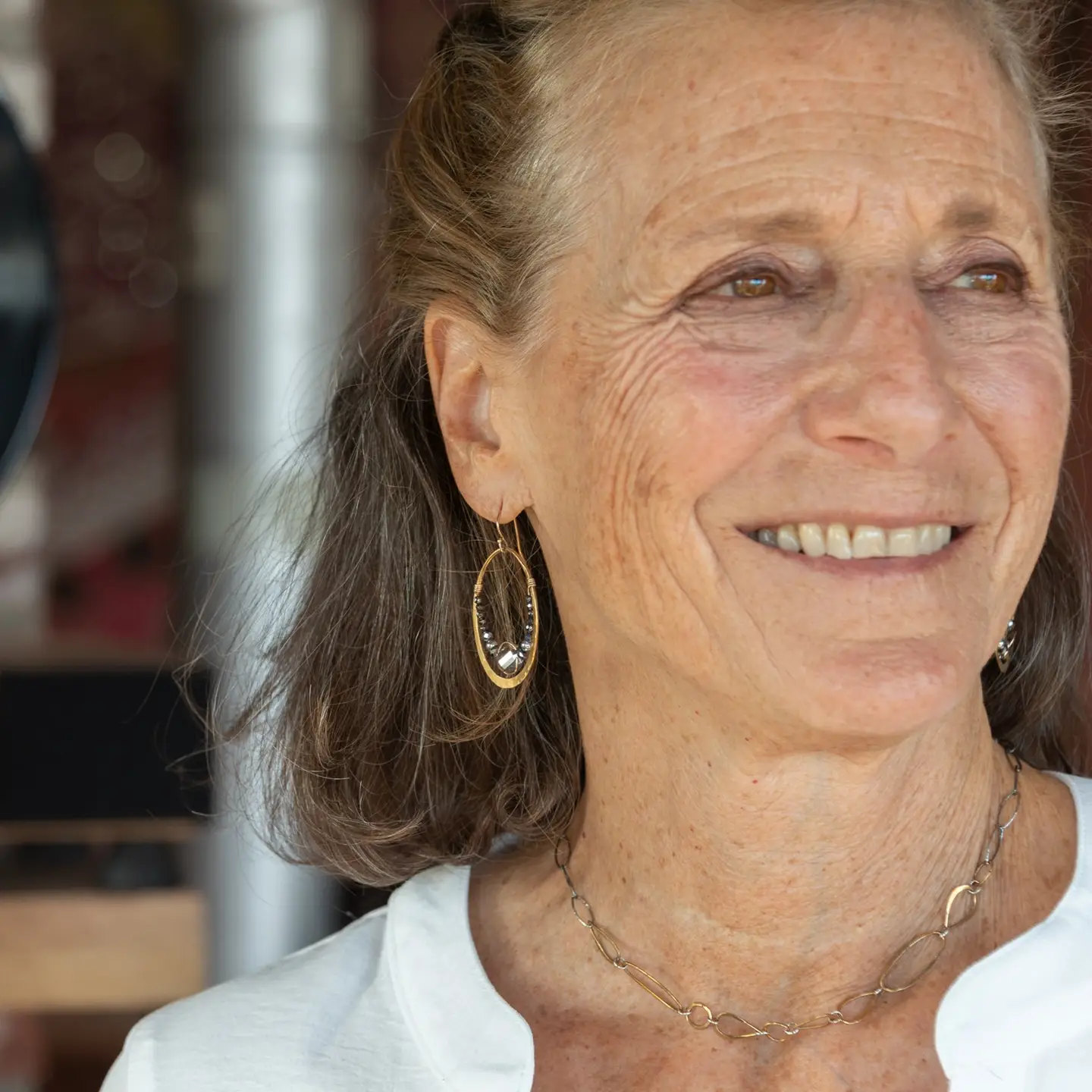 pyrite gemstones mixed with a silver sparkling coin crystal wrapped in gold filled wire inside a brass hammered hoop on gold filled earring hooks