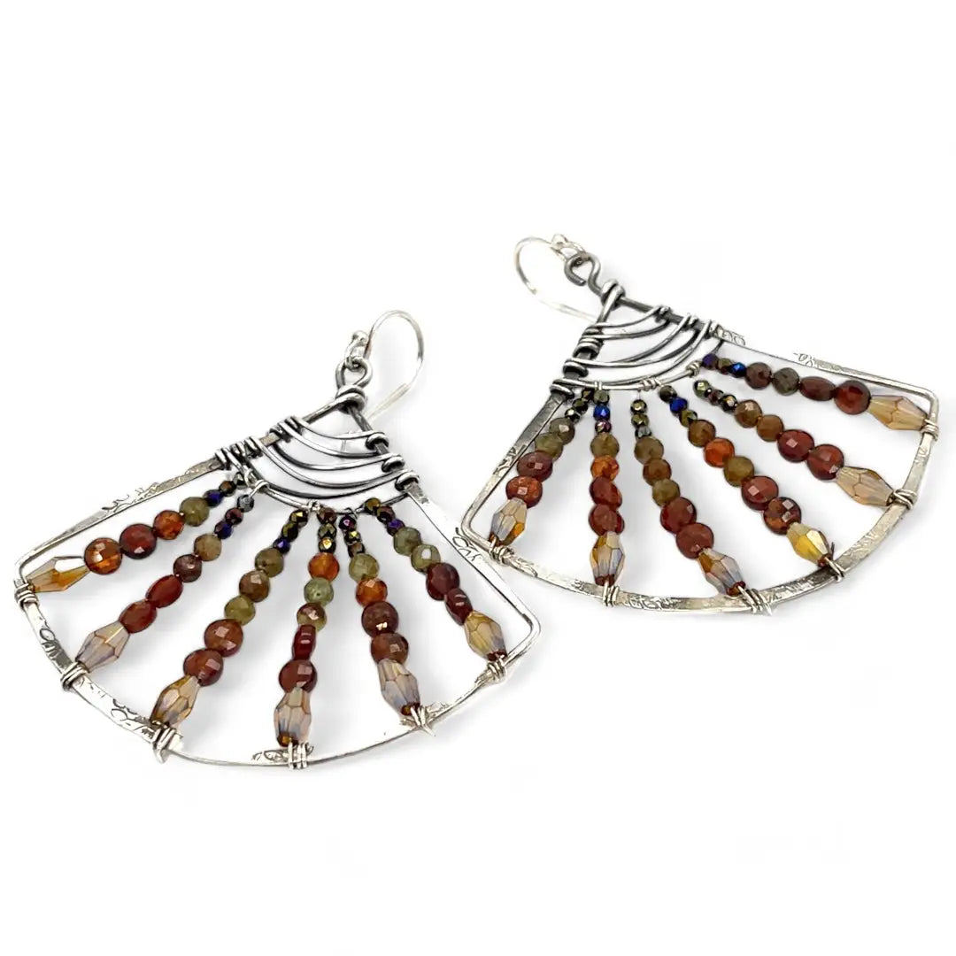 A pair of sterling silver fan earrings with micro faceted hessonite garnet gemstones and crystal