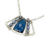 London blue quartz pointed gemstone sits at the center of mini sterling silver pendant with light blue/purple fresh water pearls