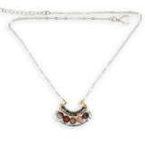 Brown striped agate coins line the inside of a sterling silver and brass fan shaped pendant necklace with pyrite and gold fill accents