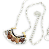 Brown striped agate coins line the inside of a sterling silver and brass fan shaped pendant necklace with pyrite and gold fill accents