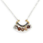 Brown striped agate coins line the inside of a sterling silver and brass fan shaped pendant necklace with pyrite and gold fill accents