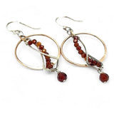 A pair of red garnet faceted gemstone earrings with sterling silver twists and bronze hoops