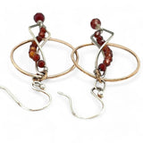 A pair of red garnet faceted gemstone earrings with sterling silver twists and bronze hoops