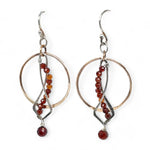 A pair of red garnet faceted gemstone earrings with sterling silver twists and bronze hoops