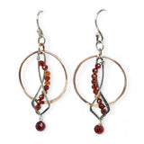 A pair of red garnet faceted gemstone earrings with sterling silver twists and bronze hoops