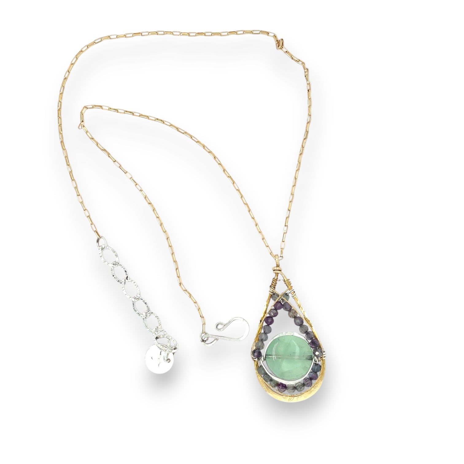 A gold-filled chain necklace with a hand formed brass pendant featuring faceted green to purple natural fluorite gemstones, and a smooth fluorite green gemstone held within sterling silver wire