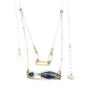 A double strand necklace with a geometric design, featuring fluorite and iolite faceted gemstones, hammered sterling silver, textured sterling silver links and handmade brass rings