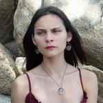 A sterling silver oval pendant necklace with a green fluorite smooth coin and micro faceted mixed gemstones, featuring an oxidized sterling silver dot chain 
