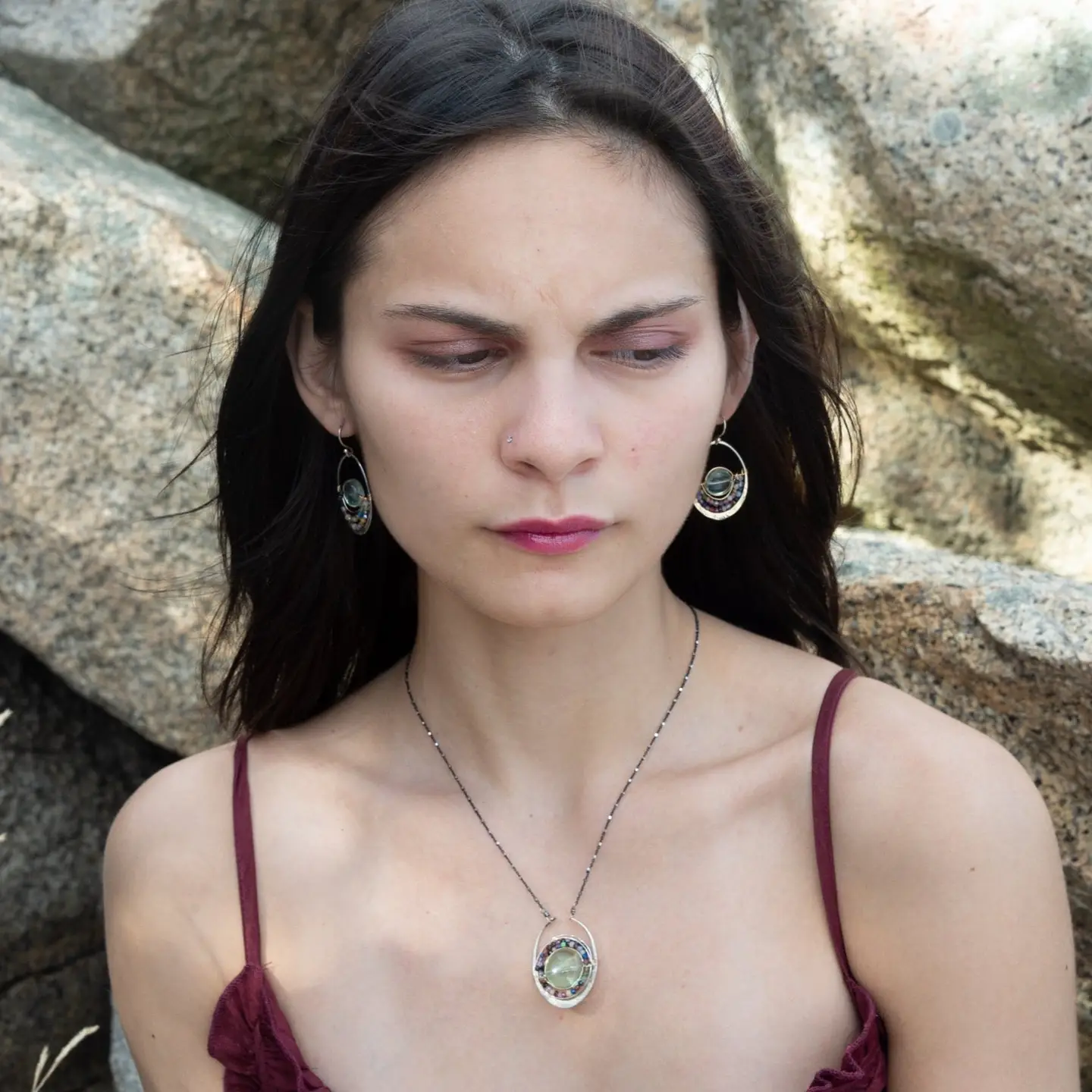 A sterling silver oval pendant necklace with a green fluorite smooth coin and micro faceted mixed gemstones, featuring an oxidized sterling silver dot chain 
