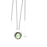 A sterling silver oval pendant necklace with a green fluorite smooth coin and micro faceted mixed gemstones, featuring an oxidized sterling silver dot chain 