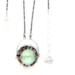 A sterling silver oval pendant necklace with a green fluorite smooth coin and micro faceted mixed gemstones, featuring an oxidized sterling silver dot chain 