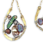 multi color fresh water pearl collection inside open hammered brass hoop earrings hanging from gold filled box chain