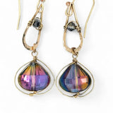 A pair of gold-filled wrapped fuchsia two-toned hematite crystal drop earrings with a hammered bronze mini drop and a crystal accent on gold filled earring hooks