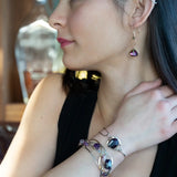 A pair of gold-filled wrapped fuchsia two-toned hematite crystal drop earrings with a hammered bronze mini drop and a crystal accent on gold filled earring hooks